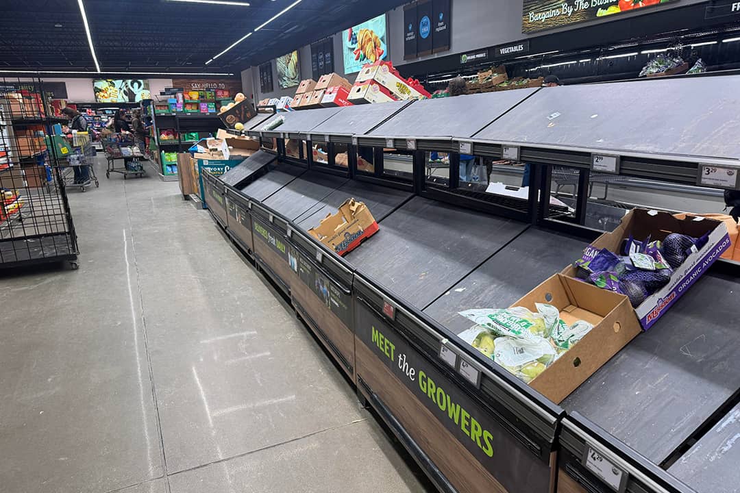 Empty shelves of fresh produce seen inside a grocery store.